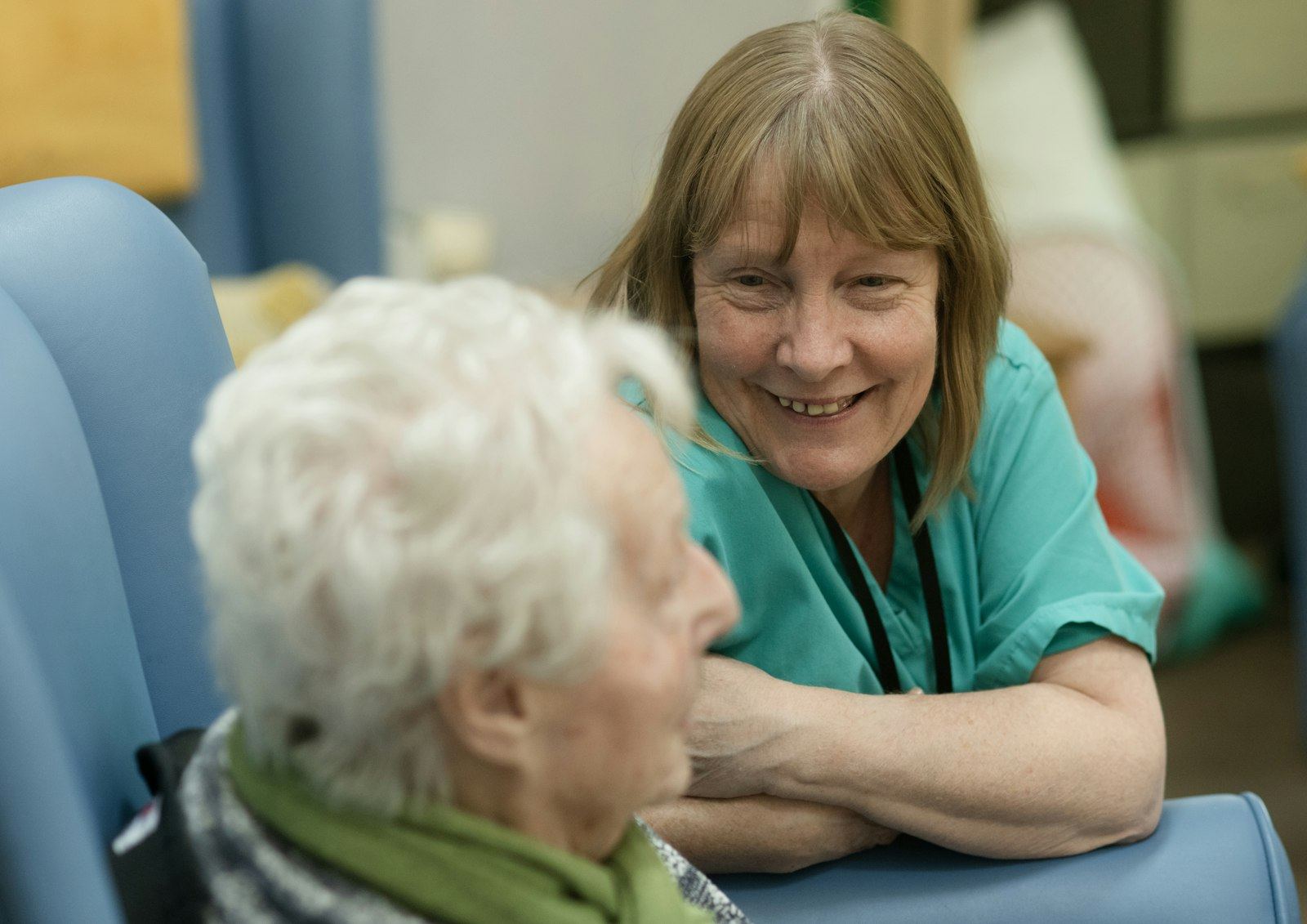 Occupational therapist and client talking together in comfortable armchairs