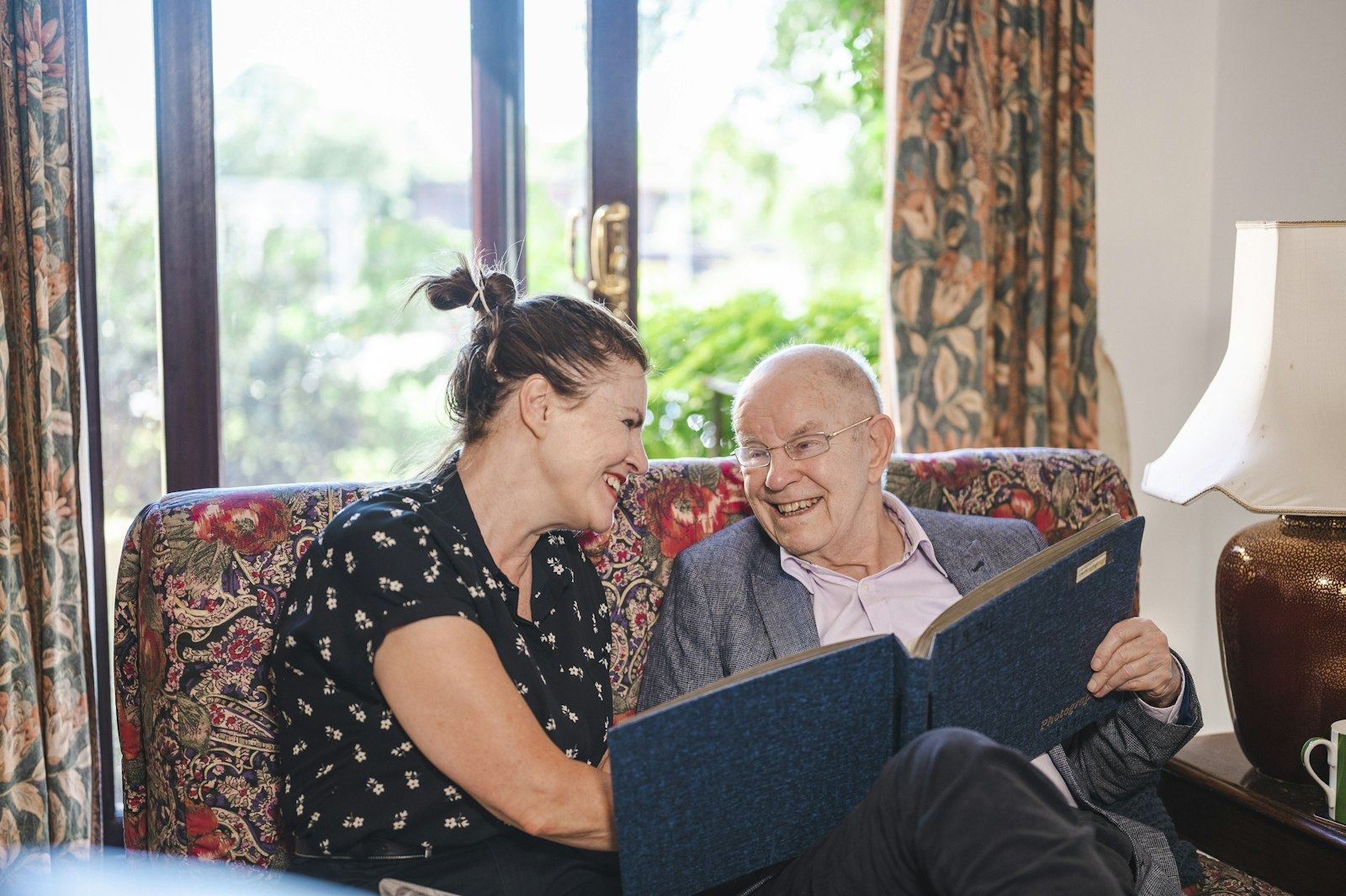 Occupational therapist and client during a home consultation on the sofa